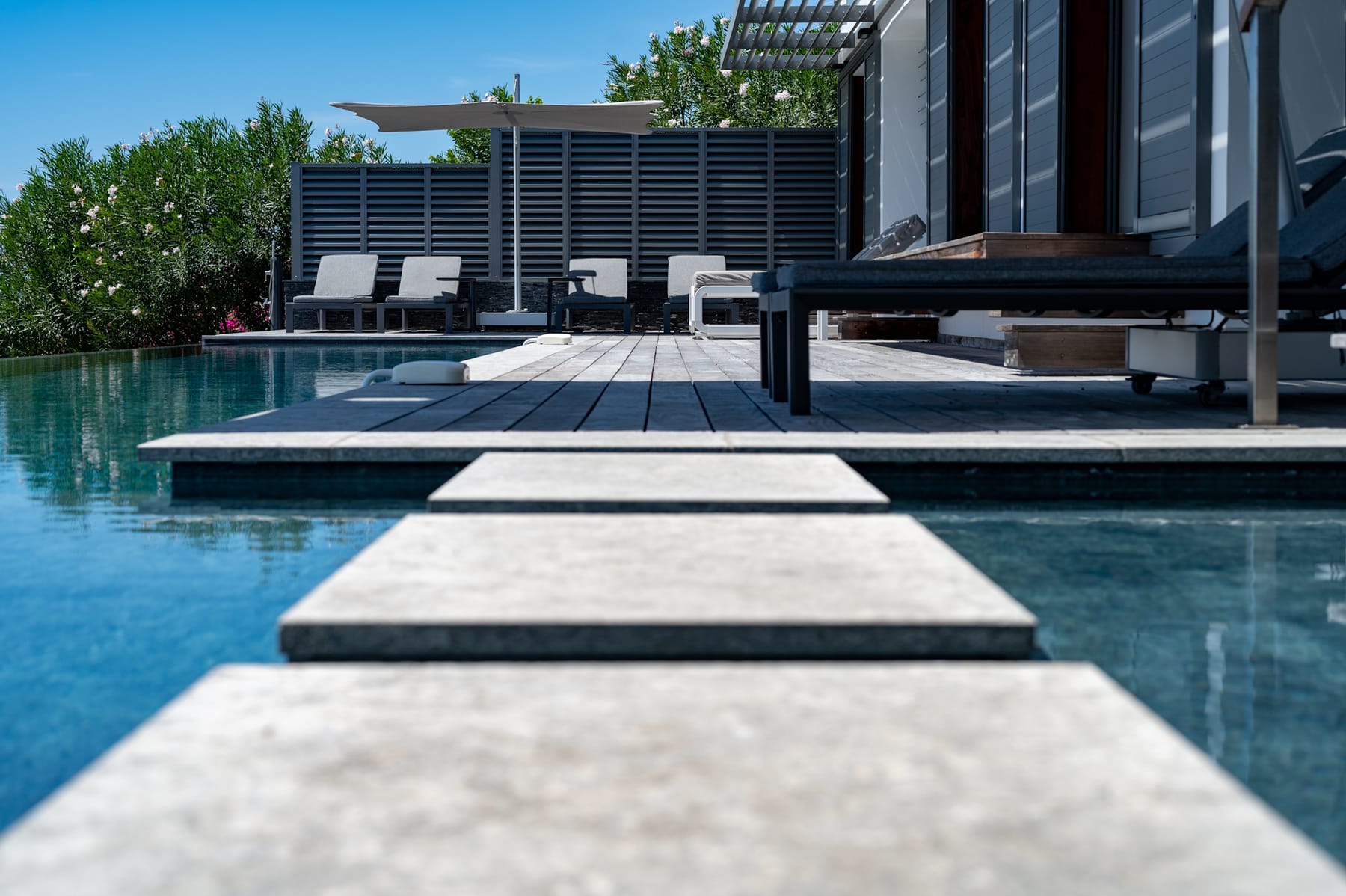 Piscine à débordement avec plots et vue mer